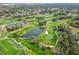 Aerial view of golf course and surrounding landscape at 2209 Calusa Lakes Blvd, Nokomis, FL 34275