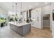 Large kitchen island with white quartz countertop and gray cabinets at 2209 Calusa Lakes Blvd, Nokomis, FL 34275