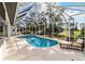 Enclosed pool and spa area with comfortable seating at 2209 Calusa Lakes Blvd, Nokomis, FL 34275