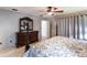 Spacious bedroom with a large bed, dresser, and ceiling fan at 22498 Westchester Blvd, Punta Gorda, FL 33980