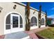 Front entrance with arched windows and a screened porch at 22498 Westchester Blvd, Punta Gorda, FL 33980