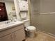 Bathroom with toilet, sink, and shower at 2395 Harbor Blvd # 117B, Port Charlotte, FL 33952