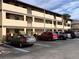 Condo building with parking lot and surrounding landscaping at 2395 Harbor Blvd # 117B, Port Charlotte, FL 33952