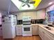 Bright kitchen with white appliances and wooden cabinets at 2395 Harbor Blvd # 117B, Port Charlotte, FL 33952