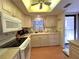 Kitchen with white appliances and wooden cabinets at 2395 Harbor Blvd # 117B, Port Charlotte, FL 33952