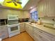 Well-equipped kitchen with white appliances and wooden cabinets at 2395 Harbor Blvd # 117B, Port Charlotte, FL 33952