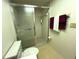 Clean bathroom with shower stall, toilet and linen storage at 2395 Harbor Blvd # 324B, Port Charlotte, FL 33952