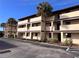 Condo building with palm trees and parking at 2395 Harbor Blvd # 324B, Port Charlotte, FL 33952