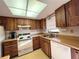 Kitchen with wood cabinets, appliances, and a window at 2395 Harbor Blvd # 324B, Port Charlotte, FL 33952