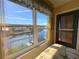 Bedroom with water views, featuring a comfy bed and large windows at 2601 W Marion Ave # 45C, Punta Gorda, FL 33950