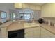 Modern kitchen with dishwasher and view to living room at 2601 W Marion Ave # 45C, Punta Gorda, FL 33950