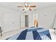 Bedroom with ceiling fan, large bed, and access to bathroom at 312 E Tarpon Nw Blvd, Port Charlotte, FL 33952