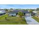 Single story home with attached garage and lush landscaping at 312 E Tarpon Nw Blvd, Port Charlotte, FL 33952