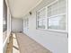 Bright and airy front porch with tile flooring and access to the front door at 312 E Tarpon Nw Blvd, Port Charlotte, FL 33952