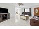 Bright living room with marble floors, brown leather couches, and a coffee table at 312 E Tarpon Nw Blvd, Port Charlotte, FL 33952