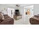 Bright living room with marble floors, brown leather couches, and a coffee table at 312 E Tarpon Nw Blvd, Port Charlotte, FL 33952