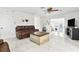 Bright living room with marble floors, brown leather couches, and a coffee table at 312 E Tarpon Nw Blvd, Port Charlotte, FL 33952