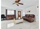 Bright living room with marble floors, brown leather couches, and a coffee table at 312 E Tarpon Nw Blvd, Port Charlotte, FL 33952