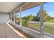 Spacious screened porch with tile flooring, offering views of lush landscaping at 312 E Tarpon Nw Blvd, Port Charlotte, FL 33952