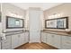 Double vanity bathroom with granite countertops and large mirrors at 316 Antis Dr, Rotonda West, FL 33947