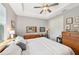 Main bedroom with king bed, wood dresser, and ceiling fan at 316 Antis Dr, Rotonda West, FL 33947