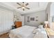 King bed, wood dresser, and ceiling fan in bedroom at 316 Antis Dr, Rotonda West, FL 33947