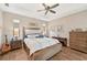 King-size bed and ceiling fan in main bedroom at 316 Antis Dr, Rotonda West, FL 33947