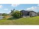 Single-story home with a screened-in patio and lake view at 316 Antis Dr, Rotonda West, FL 33947