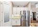 Stainless steel refrigerator and white cabinets in kitchen at 316 Antis Dr, Rotonda West, FL 33947