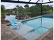 Beautiful pool with chairs inside and a scenic view of the pond and backyard at 316 Antis Dr, Rotonda West, FL 33947