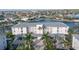 Aerial view of condo building, parking, and waterfront access at 3640 Bal Harbor Blvd # 313, Punta Gorda, FL 33950