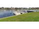 Private boat dock with two boat slips and lush green lawn at 3640 Bal Harbor Blvd # 313, Punta Gorda, FL 33950