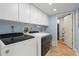 Well-lit laundry room with cabinets and modern Whirlpool appliances at 3640 Bal Harbor Blvd # 313, Punta Gorda, FL 33950