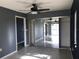 Bedroom with mirrored closet doors and ceiling fan at 4127 Gardner Dr, Port Charlotte, FL 33952