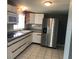 Kitchen with stainless steel refrigerator and white cabinets at 4127 Gardner Dr, Port Charlotte, FL 33952