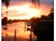 Stunning sunset over the canal, showcasing a relaxing waterfront view at 4127 Gardner Dr, Port Charlotte, FL 33952