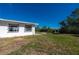 White house exterior with a large yard. Needs some landscaping and exterior updates at 414 Glenholm Ave, Punta Gorda, FL 33950