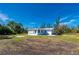 White house exterior, side view, with a large yard at 414 Glenholm Ave, Punta Gorda, FL 33950