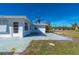 White house exterior, side view, with a large yard and patio at 414 Glenholm Ave, Punta Gorda, FL 33950