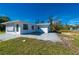 White house exterior, side view, with a large yard and patio at 414 Glenholm Ave, Punta Gorda, FL 33950