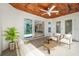 Relaxing back patio with wooden ceiling, ceiling fan, and access to the kitchen at 509 Sunset N Rd, Rotonda West, FL 33947