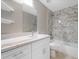 Updated bathroom with white cabinets, marble-look tile, and a bathtub at 509 Sunset N Rd, Rotonda West, FL 33947