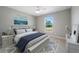 Bright bedroom with a queen-size bed, large window, and hardwood floors at 509 Sunset N Rd, Rotonda West, FL 33947