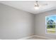 Spacious bedroom with a ceiling fan and large window, offering natural light at 509 Sunset N Rd, Rotonda West, FL 33947