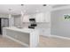 Modern kitchen with white cabinets and a large island at 509 Sunset N Rd, Rotonda West, FL 33947