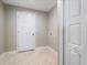 Laundry room with white door and light beige walls at 509 Sunset N Rd, Rotonda West, FL 33947