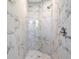 Large walk-in shower with marble-look tile at 509 Sunset N Rd, Rotonda West, FL 33947