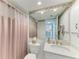 Bathroom with a pink shower curtain and a vanity with a quartz countertop at 601 Shreve St # 46A, Punta Gorda, FL 33950