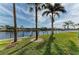 Peaceful waterfront view with lush grass and palm trees at 601 Shreve St # 46A, Punta Gorda, FL 33950