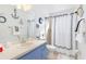 Bathroom with blue vanity, shower, and nautical theme at 604 Foxwood Blvd, Englewood, FL 34223